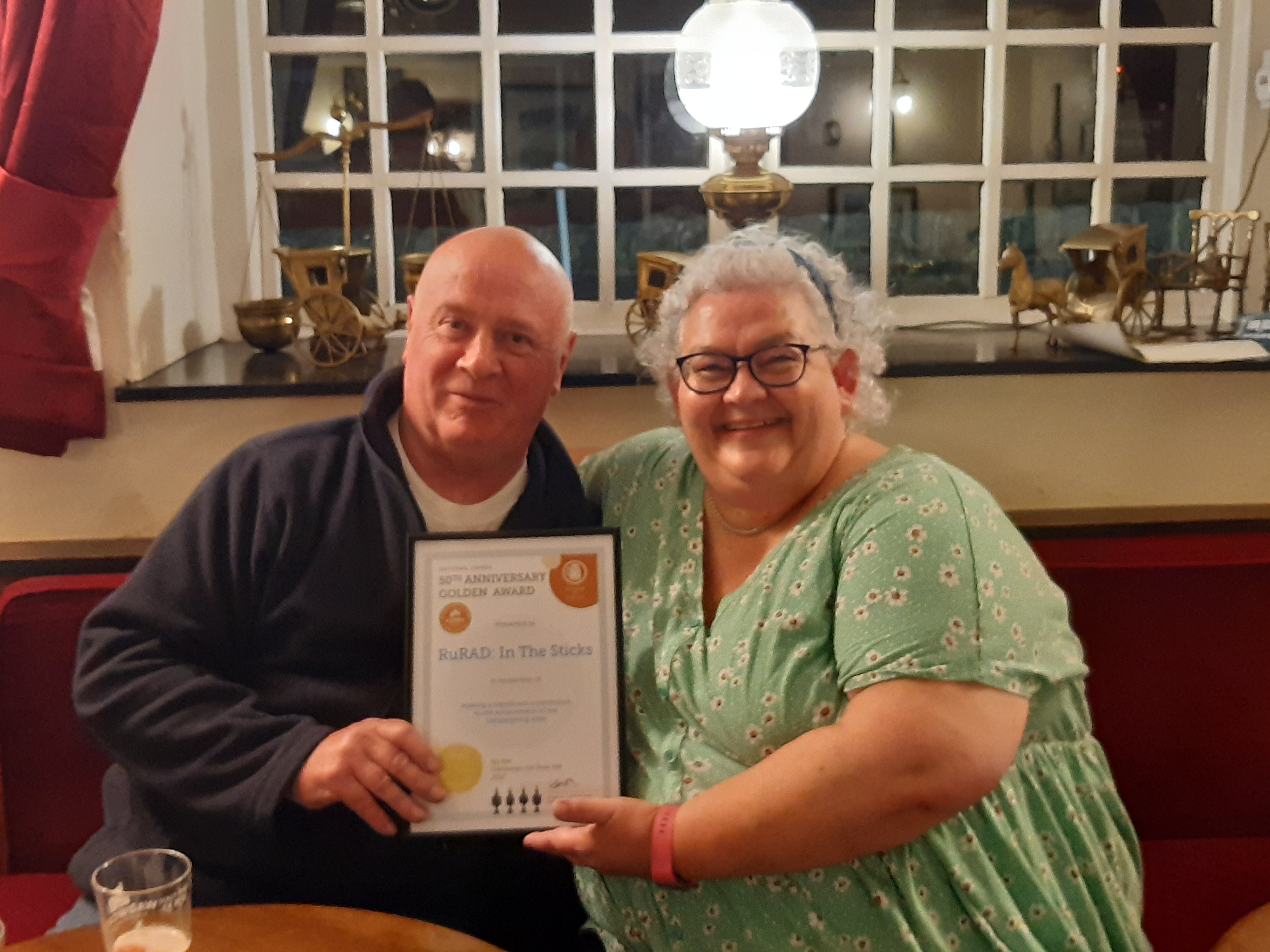 Gillian Hough presenting a 50th Golden Award Certificate to Paul Eyden of RuRad